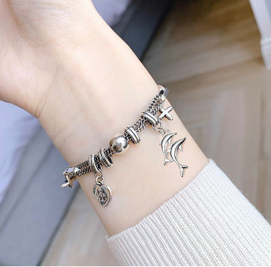 Silver and gold dolphin charms
